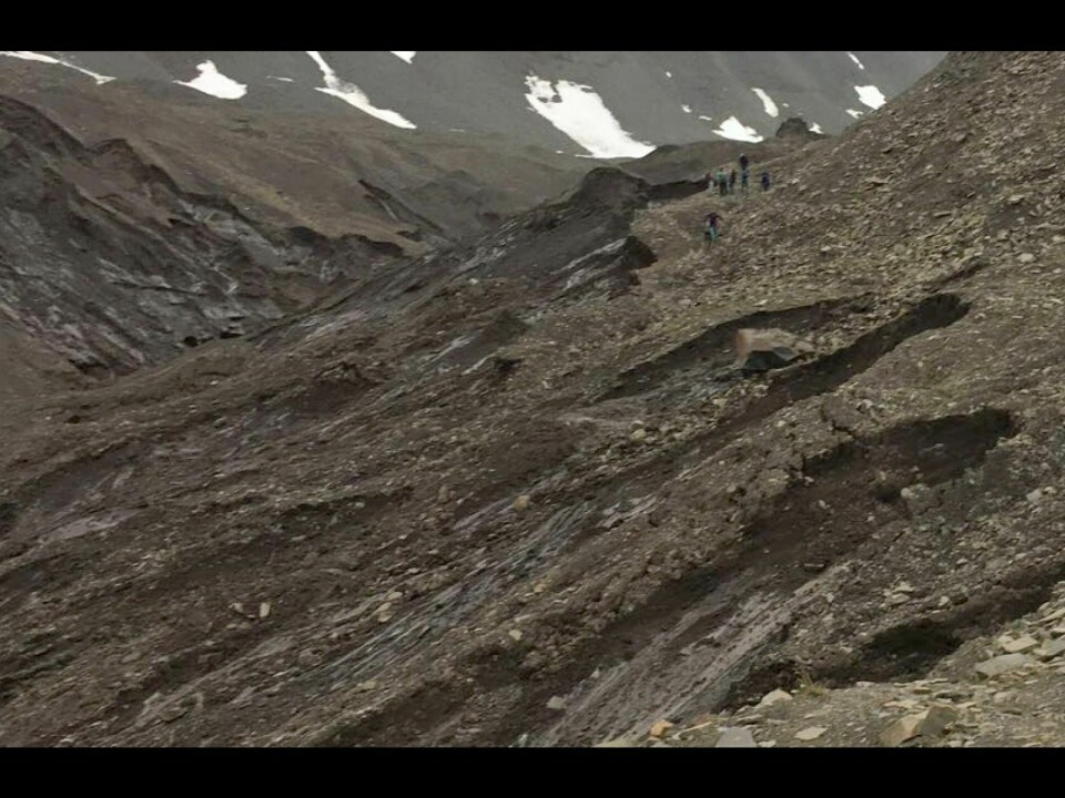A group hikes just above a ridge where a landslide occurred. Knut Aune Hoseth, regional director of the Norwegian Water Resources and Energy Directorate (NVE), is asking people to stay away from such areas.