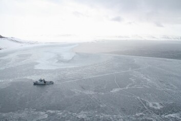 KV «Svalbard» in Tempelfjorden. On the picture you can see the scooter tracks and the holes in the ice.